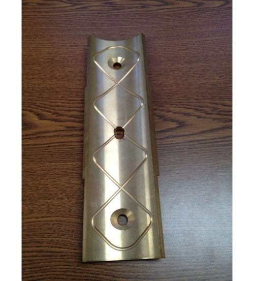 Close-up of a precision-machined brass part. Metal fabrication services offered by SC Industries in Houston.