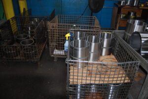 Metal cylinders showing in storage at SC Industries. Quality parts are on display.