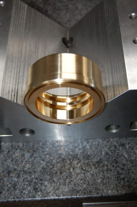 Metal ring placed in a precision quality measurement tool at SC Industries.