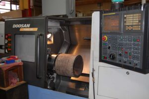 Doosan PUMA 300 CNC Machine with metal part inside. SC Industries, Houston.