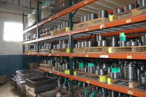 Organized storage of finished metal parts at SC Industries, showcasing inventory management and efficiency.