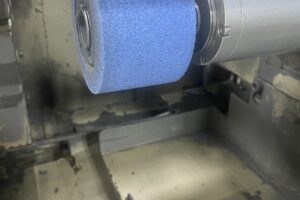 Polishing a metal part on a industrial grinder at SC Industries, Houston. Polishing a metal part on a industrial grinder at SC Industries, Houston.