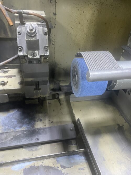 Precision metal finishing process using a polishing wheel at SC Industries in Houston, TX.