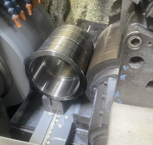 Large metal cylinder machining process in a industrial machining shop at SC Industries in Houston.
