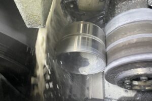 Coolant washing off a metal part after machining process, metal fabrication services at SC Industries in Houston. Coolant washing off a metal part after machining process, metal fabrication services at SC Industries in Houston.