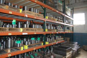 Organized inventory of finished metal parts at SC Industries, showcasing efficiency and quality.