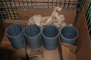 Finished metal cylinders, packaged for shipping, at SC Industries, Houston.